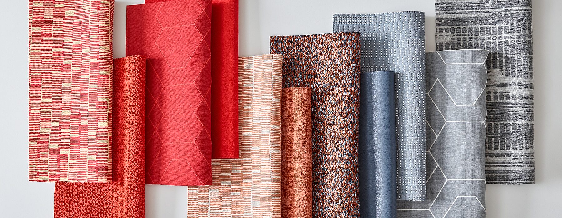 fabric samples laid out ranging from red to blue to gray